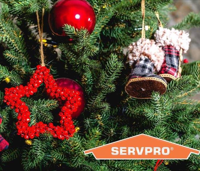 Christmas tree with ornaments and SERVPRO logo superimposed