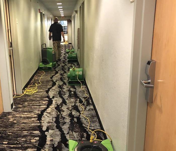 Drying equipment in hallway of water damaged Jacksonville hotel.